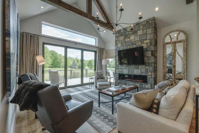 living area featuring wood finished floors, a stone fireplace, a chandelier, high vaulted ceiling, and recessed lighting