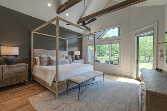 bedroom with wood finished floors, beamed ceiling, access to exterior, and high vaulted ceiling