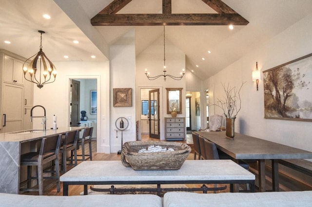 dining area featuring beam ceiling, recessed lighting, and an inviting chandelier