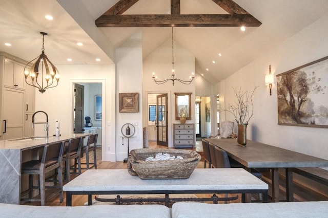 dining room with a chandelier, beamed ceiling, recessed lighting, light wood-style floors, and high vaulted ceiling