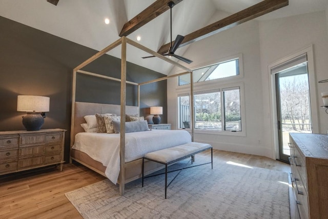 bedroom with light wood finished floors, beamed ceiling, high vaulted ceiling, and access to outside