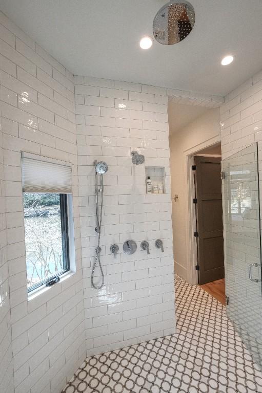 full bathroom featuring recessed lighting and tiled shower