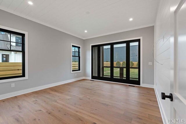 bathroom with hardwood / wood-style floors, a shower with shower door, and vanity