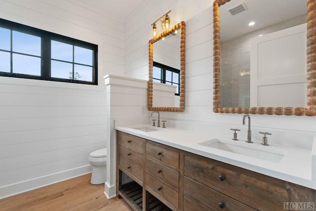 bathroom with hardwood / wood-style floors, toilet, and vanity