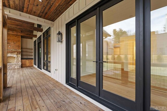 back of property with a balcony, central AC unit, a yard, and a sunroom