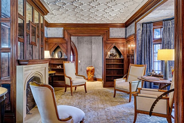 581 Sagee Woods Dr, Highlands, NC 28741 - sitting room with crown molding, built in features, and a fireplace