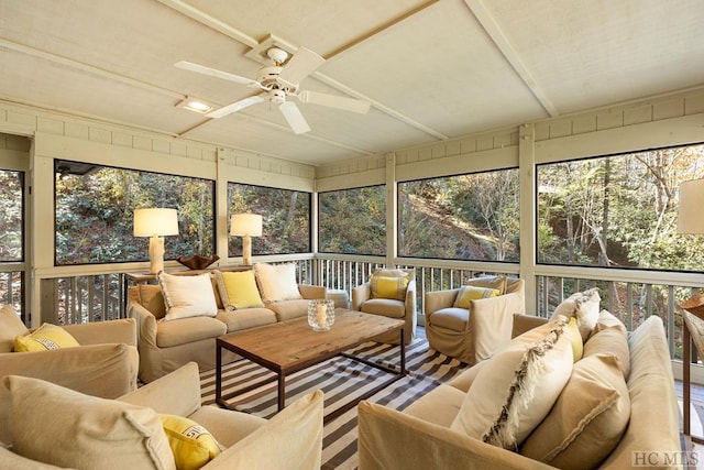 sunroom featuring ceiling fan and plenty of natural light