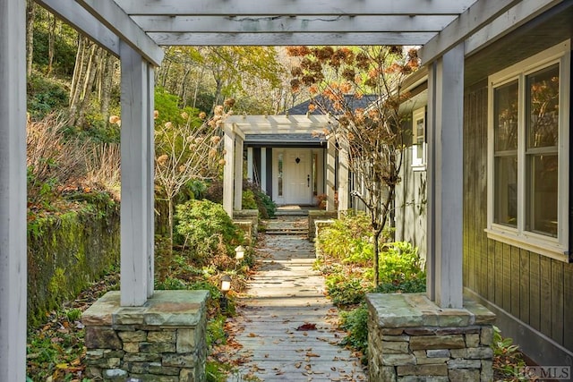 doorway to property with a pergola