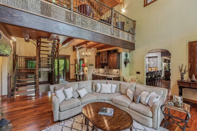 18 Buck Knob Is, Glenville, NC 28723 - living area with wood finished floors, stairs, a chandelier, arched walkways, and beam ceiling