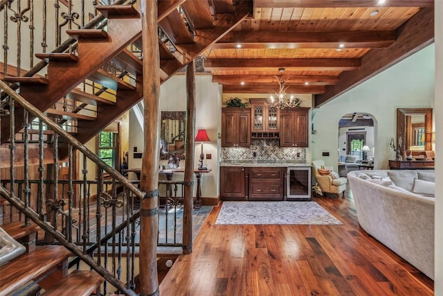 18 Buck Knob Is, Glenville, NC 28723 - living area with wine cooler, arched walkways, dark wood-type flooring, wooden ceiling with exposed beams, and stairway