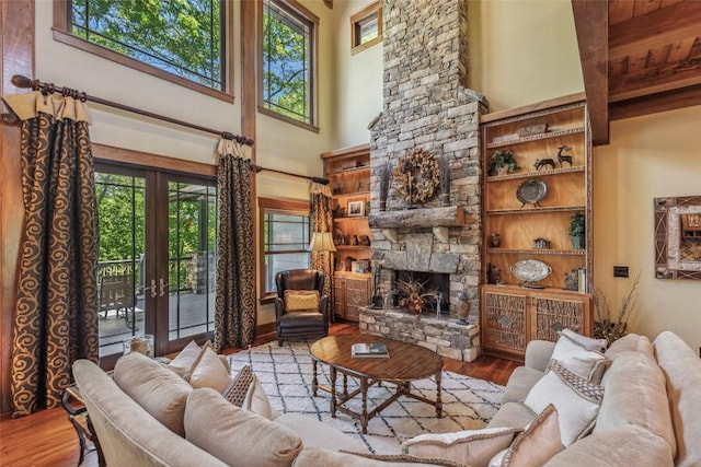 18 Buck Knob Is, Glenville, NC 28723 - living room with a high ceiling, wood finished floors, french doors, and a stone fireplace