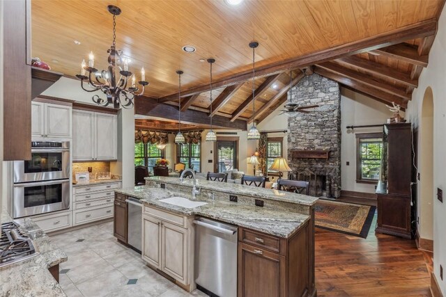 18 Buck Knob Is, Glenville, NC 28723 - kitchen with wooden ceiling with exposed beams, appliances with stainless steel finishes, a sink, open floor plan, and light stone counters