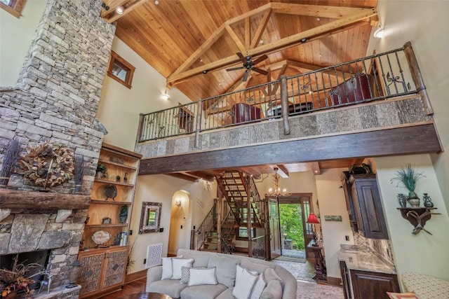 18 Buck Knob Is, Glenville, NC 28723 - living area featuring high vaulted ceiling, stairway, wooden ceiling with exposed beams, a stone fireplace, and baseboards