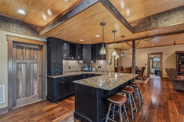 18 Buck Knob Is, Glenville, NC 28723 - kitchen with dark wood-style floors, a kitchen bar, light stone countertops, a peninsula, and wood ceiling
