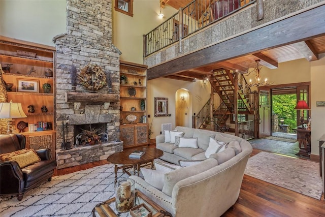 18 Buck Knob Is, Glenville, NC 28723 - living room featuring arched walkways, a towering ceiling, wood finished floors, stairs, and a chandelier
