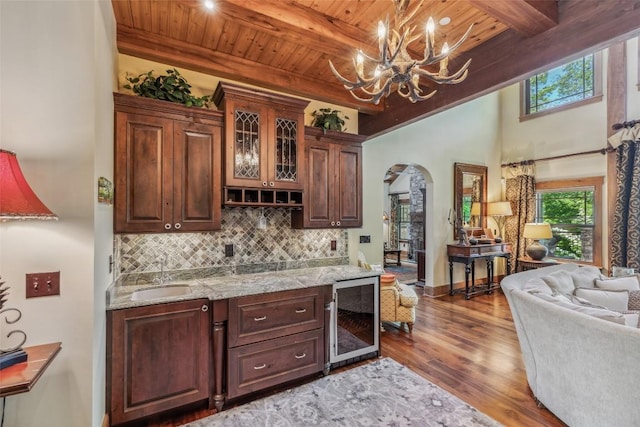 18 Buck Knob Is, Glenville, NC 28723 - indoor wet bar featuring wine cooler, arched walkways, a chandelier, wooden ceiling with exposed beams, and wood finished floors