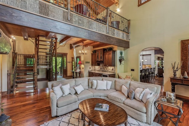 18 Buck Knob Is, Glenville, NC 28723 - living area with wood finished floors, stairs, a chandelier, arched walkways, and beam ceiling