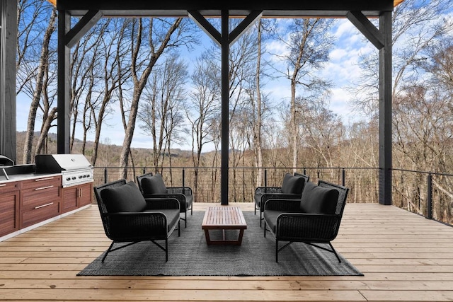 99 Springhead Trl, Cullowhee, NC 28723 - wooden terrace featuring area for grilling, a view of trees, an outdoor kitchen, and outdoor lounge area