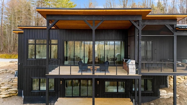 99 Springhead Trl, Cullowhee, NC 28723 - back of house with board and batten siding and a sunroom