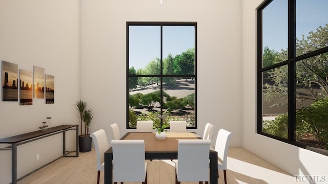 dining space with light wood-type flooring and a wealth of natural light