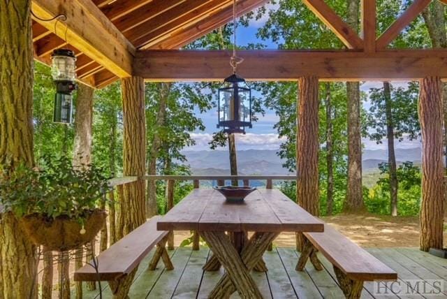 sunroom with lofted ceiling and a mountain view