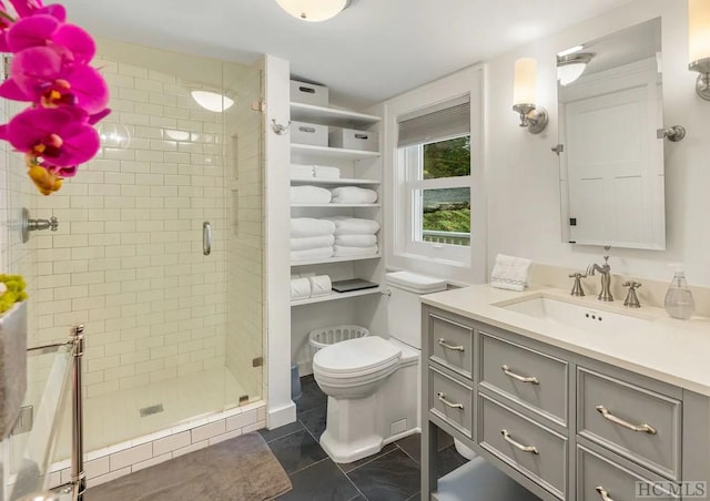 bathroom featuring an enclosed shower, vanity, tile patterned floors, and toilet