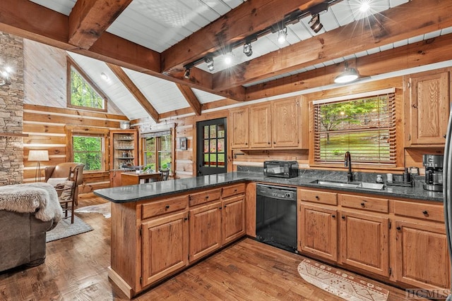 kitchen with kitchen peninsula, sink, beam ceiling, hardwood / wood-style floors, and black dishwasher