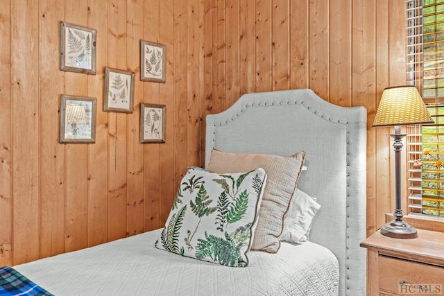 bedroom with wood walls