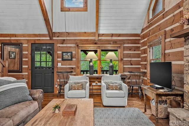 living room featuring a wealth of natural light, wood walls, hardwood / wood-style floors, and high vaulted ceiling