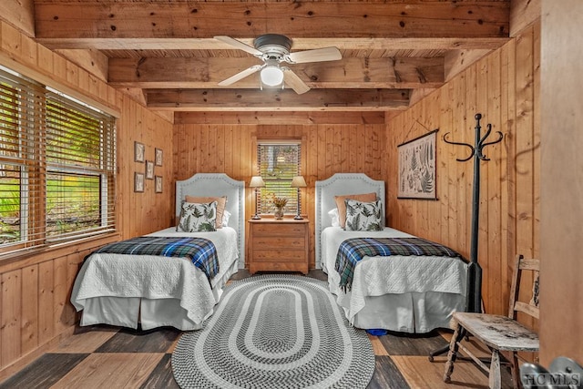 bedroom with ceiling fan, hardwood / wood-style flooring, wooden ceiling, wood walls, and beamed ceiling