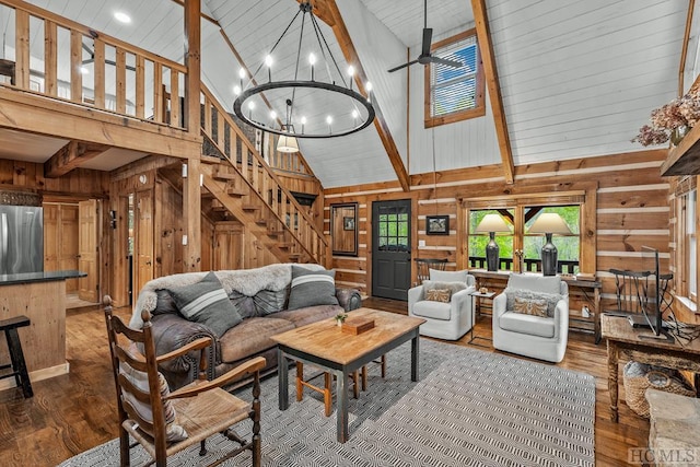 living room featuring high vaulted ceiling, dark wood-type flooring, and wood walls