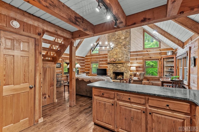 kitchen featuring light hardwood / wood-style floors, an inviting chandelier, and wooden walls