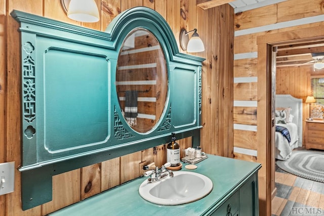 bathroom featuring vanity, wood walls, and hardwood / wood-style floors