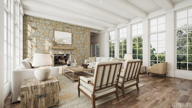 sunroom / solarium with beamed ceiling and a fireplace