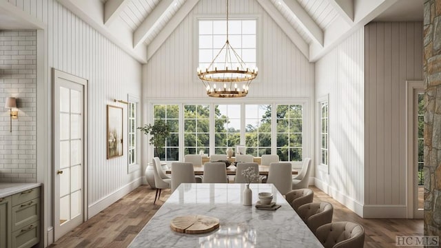 sunroom / solarium featuring an inviting chandelier and lofted ceiling