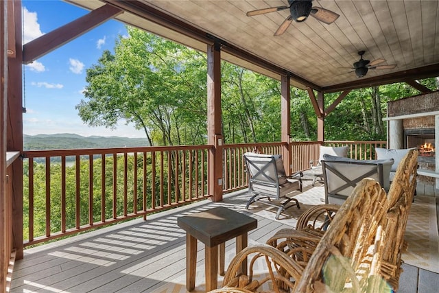 57 Loch Dr, Glenville, NC 28736 - deck featuring ceiling fan, a mountain view, and an outdoor living space with a fireplace
