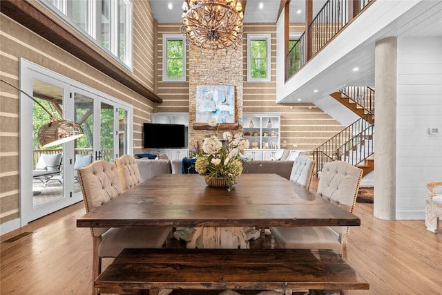 57 Loch Dr, Glenville, NC 28736 - dining area with a high ceiling, french doors, stairway, light wood finished floors, and a chandelier