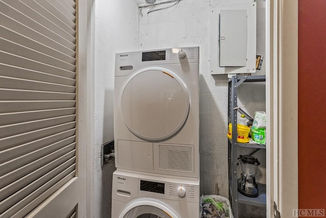 washroom featuring stacked washer and dryer and electric panel