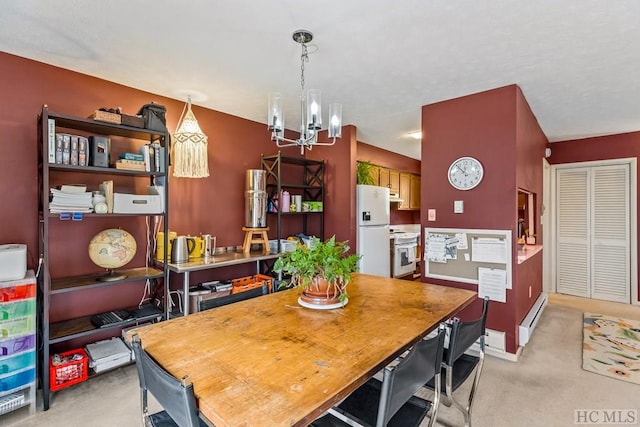 dining space with baseboard heating, an inviting chandelier, and light carpet