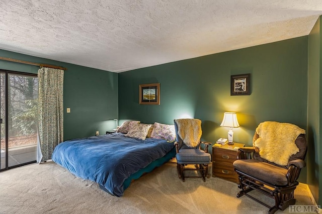 carpeted bedroom featuring access to exterior and a textured ceiling