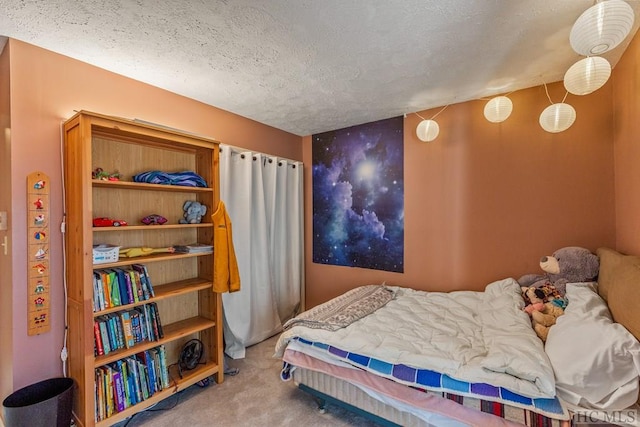 carpeted bedroom featuring a textured ceiling