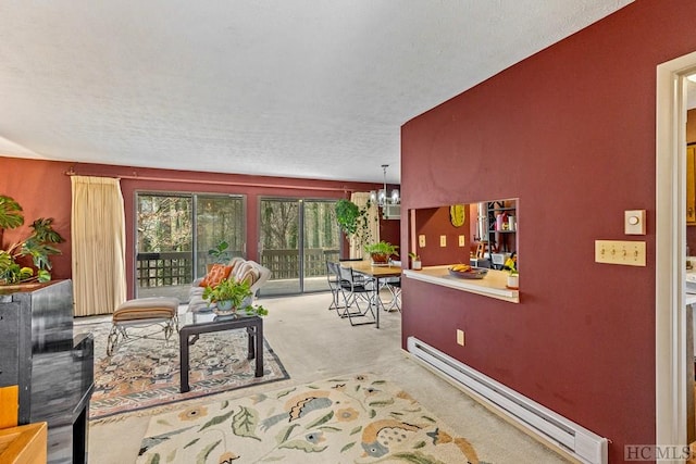 interior space with an inviting chandelier, a baseboard heating unit, and a textured ceiling