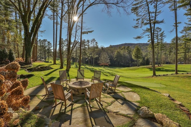 view of patio / terrace with a mountain view and a fire pit