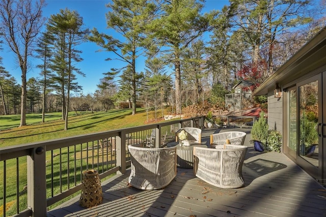 wooden terrace featuring a yard