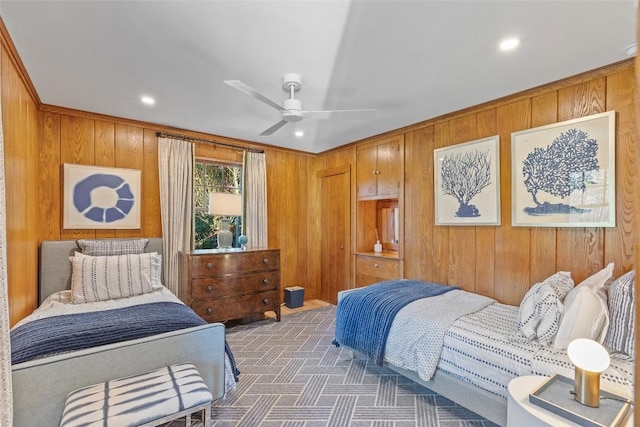 carpeted bedroom featuring recessed lighting, ceiling fan, and wood walls