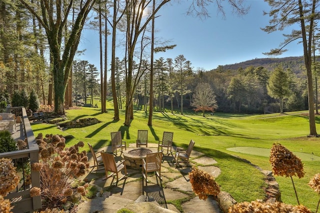 exterior space with an outdoor fire pit and a yard