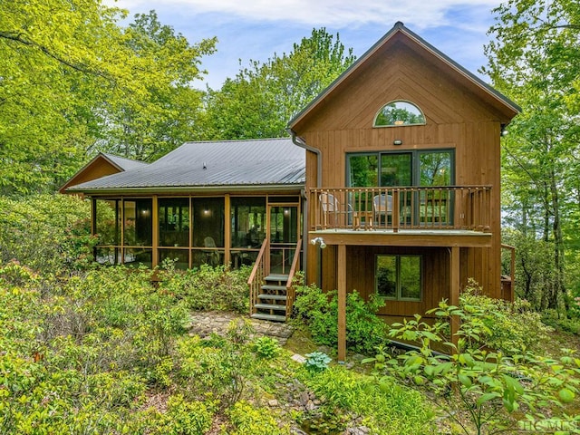 back of house with a sunroom