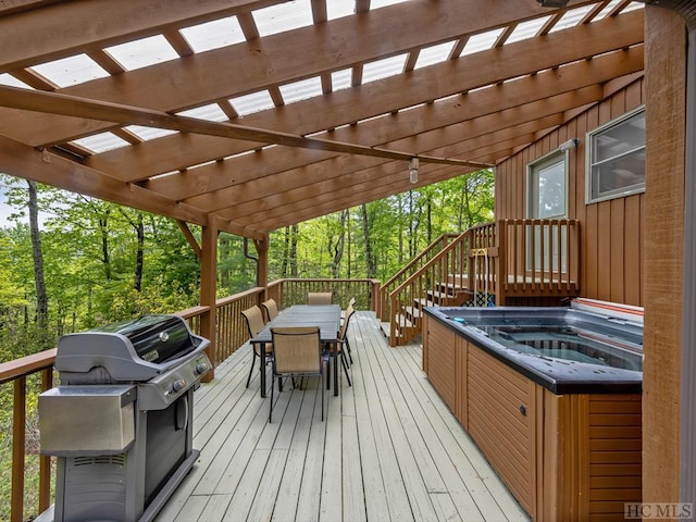 wooden terrace with a pergola, area for grilling, and a hot tub