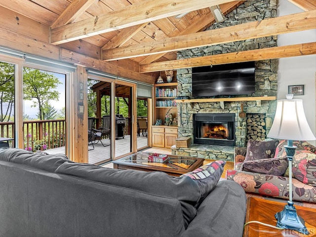 living room with lofted ceiling with beams, a fireplace, and wooden ceiling