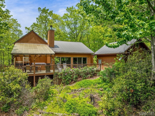 back of house featuring a wooden deck